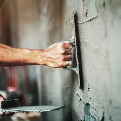 Duvara mala ile sıva çeken ustanın elleri
